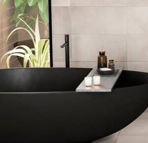 Modern black bathtub with minimalist decor.